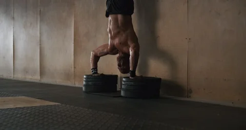 Determined mature man doing handstand push-up exercise in gym Stock Footage 116400384
