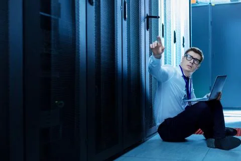 Determined operator working on his laptop Stock Photos