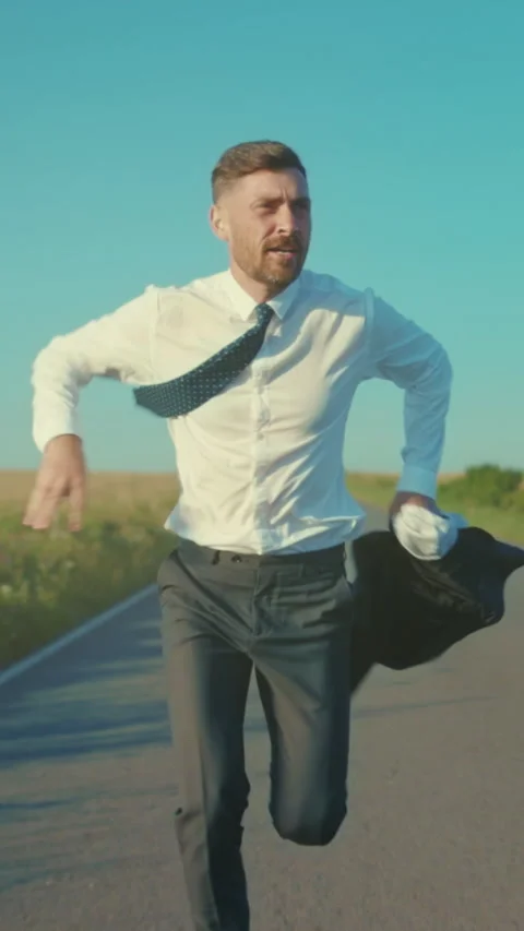 Determined professional dashes through rural landscape, An executive swiftly Stock Footage 330039043