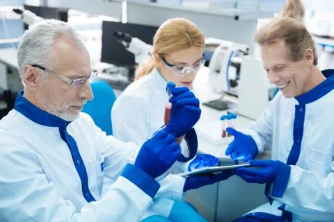 Determined researchers obtaining DNA code 写真素材
