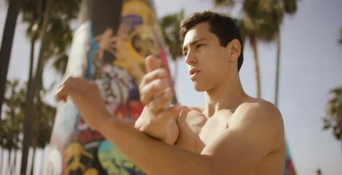 Determined shirtless man doing stretching exercise on a sunny day Stock Footage 106195015