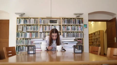 Determined student searches books while preparing for difficult final exams Stock Footage 341655553