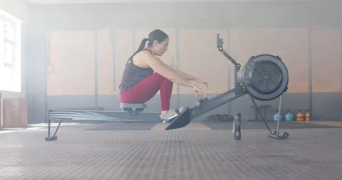 Determined unaltered woman exercising on rowing machine at gym, in slow motion 스톡 동영상 341936623