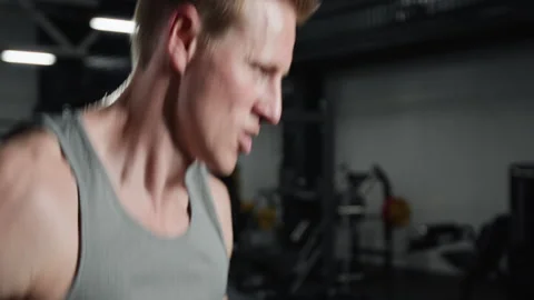 Determined Young Man Doing Intense Cardio Workout in Gym Stock Footage 339886261