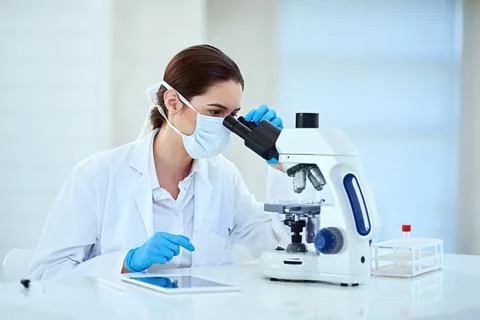 Determining the root cause of her latest medical case. Shot of a female Stock Photos