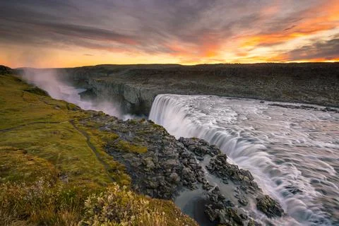 Detifoss waterfall with sunset in the background Stock Photos