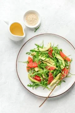 Detox grapefruit and arugula salad, top down view Stock Photos