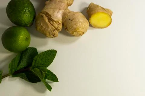 Detox tea supplement. Ginger root, mint and lime. Light background, copy space. Stock Photos