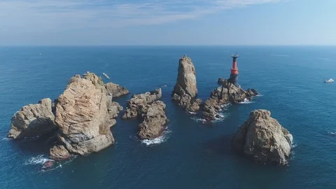 Deungdaeseom sheer cliff face wide downward aerial view in Tongyeong Stock-Footage 85713463