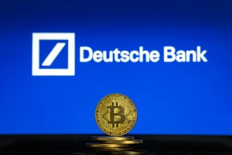 Deutsche Bank logo on a computer screen with a stack of Bitcoin crypto Stock Photos