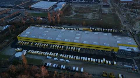 Deutsche Post logistics center with delivery vans. Best aerial view drone Stock Footage 322929987