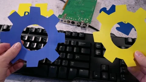 Dev and Ops symbol in hand on motherboard and keyboard background. DevOps Con Stock Footage 211807187