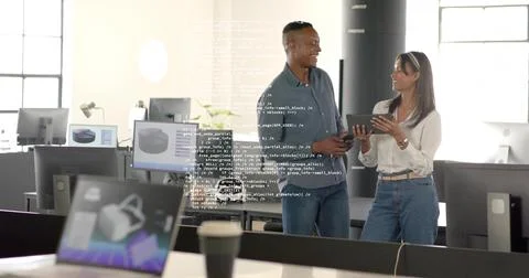 Dev in dark shirt and designer in white discussing in open office, showing Stock-Fotos