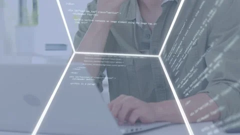 Dev lowering pen placing hands on laptop, typing to debug code with rotating Stock Footage 334744107