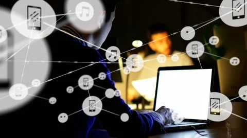 Dev typing at laptop in dim desk left icons emerging forming tech-network Stock Footage 334115233