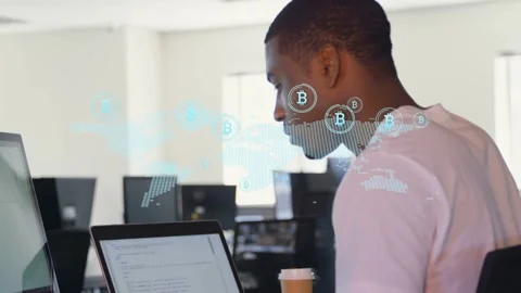 Dev typing at laptop in office, overlay sparking Bitcoin map analysis icons Stock Footage 333873711