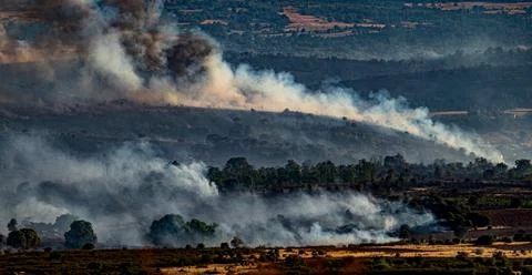Devastated field with smoke trails during the fire Stock-Fotos