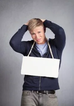 Devastated man showing white empty signboard. Stock Photos