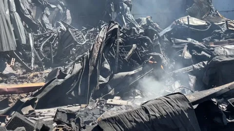 Devastating aftermath of a building fire with smoldering ruins Stock-Footage 320815636
