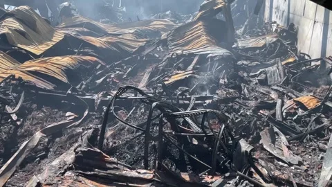 Devastating aftermath of a building fire with smoldering ruins Video stock 320815678