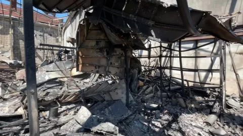 Devastating aftermath of a building fire with smoldering ruins Video stock 320815719