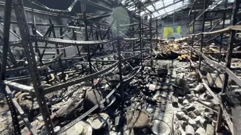 Devastating aftermath of a building fire with smoldering ruins Video stock 320815744