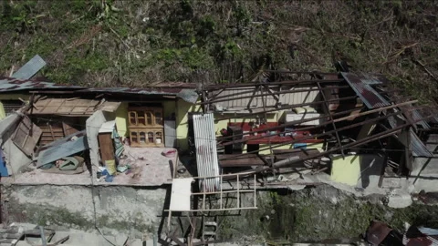 Devastating landslide destroying a residential house Stockbeeldmateriaal 334395731