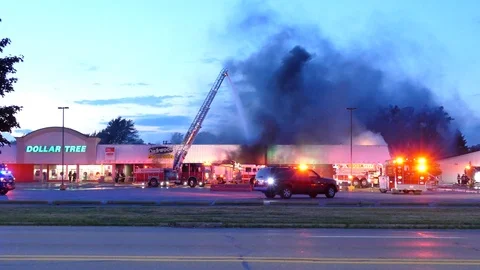 Devastating sight of a shopping mall on fire with Dollar Tree store sign Stock Footage 94860313