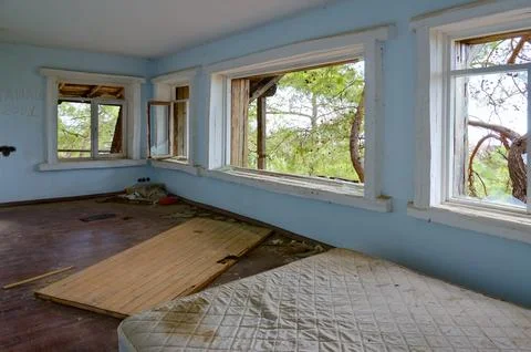 Devastation inside cottage on territory of abandoned five-star hotel Stock Photos