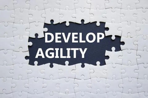 Develop agility symbol. Concept word Develop agility on white puzzle. Beaut.. Stock Photos