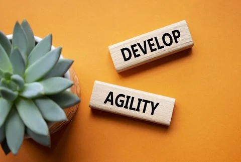 Develop agility symbol. Concept word Develop agility on wooden blocks. Beau.. Stockfoto's