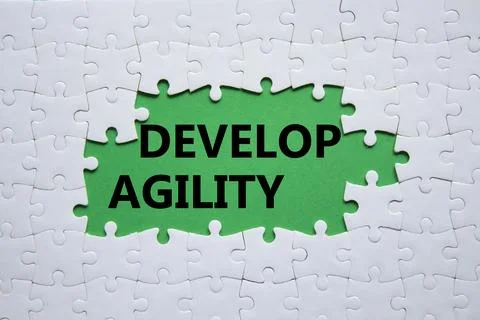 Develop agility symbol. Concept word Develop agility on white puzzle. Beaut.. Stockfoto's