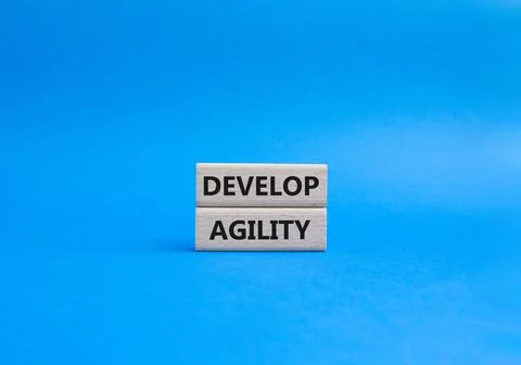 Develop agility symbol. Concept word Develop agility on wooden blocks. Beau.. Stock Photos