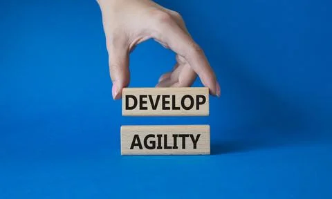 Develop agility symbol. Concept word Develop agility on wooden blocks. Busi.. Stock Photos