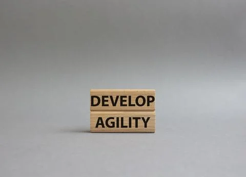 Develop agility symbol. Concept word Develop agility on wooden blocks. Beau.. Stock Photos