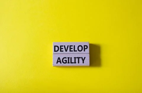 Develop agility symbol. Concept word Develop agility on wooden blocks. Beau.. Stock Photos
