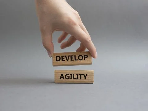 Develop agility symbol. Concept word Develop agility on wooden blocks. Beau.. Stockfoto's