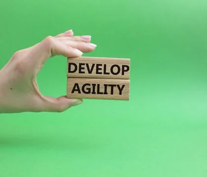 Develop agility symbol. Concept word Develop agility on wooden blocks. Beau.. Stockfoto's