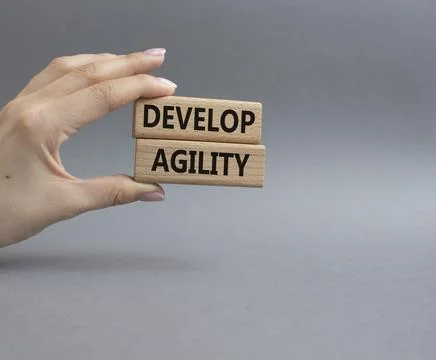 Develop agility symbol. Concept word Develop agility on wooden blocks. Beau.. Stockfoto's