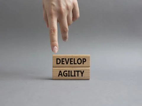 Develop agility symbol. Concept word Develop agility on wooden blocks. Beau.. Stock Photos