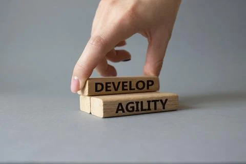 Develop agility symbol. Concept word Develop agility on wooden blocks. Busi.. Stock Photos