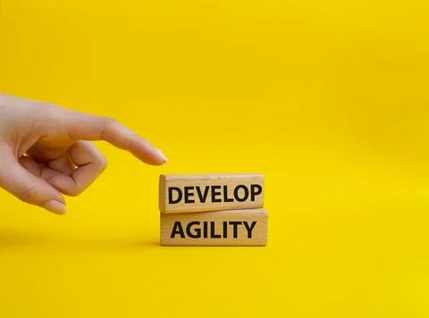 Develop agility symbol. Concept word Develop agility on wooden blocks. Beau.. 스톡 사진