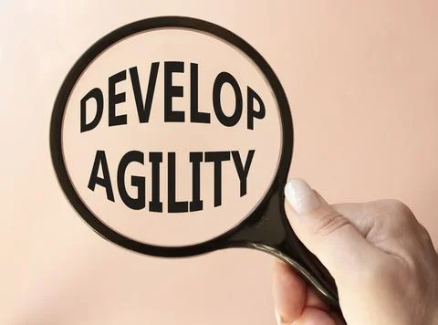 Develop agility symbol. Concept word Develop agility on magnifying glass. B.. 写真素材