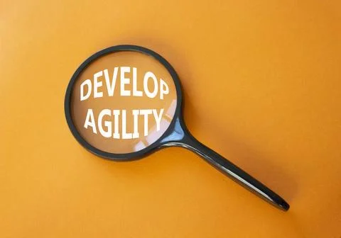 Develop agility symbol. Concept word Develop agility on magnifying glass. B.. Stockfoto's