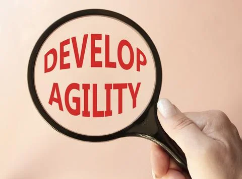 Develop agility symbol. Concept word Develop agility on magnifying glass. B.. 写真素材