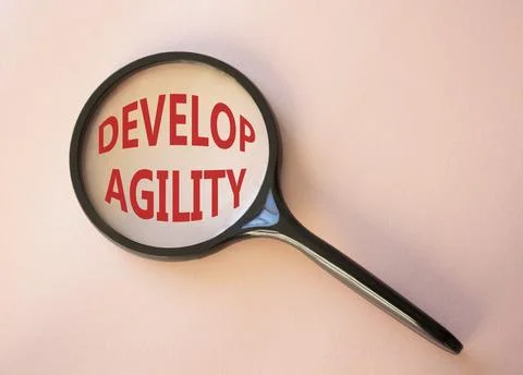 Develop agility symbol. Concept word Develop agility on magnifying glass. B.. Stockfoto's