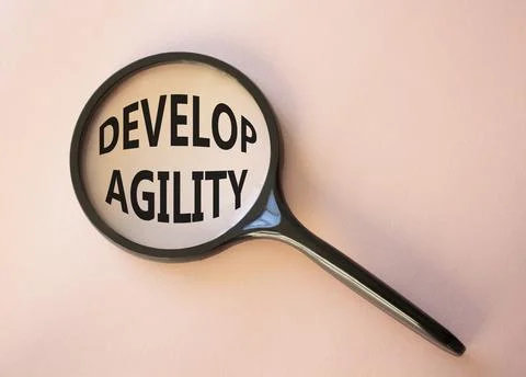 Develop agility symbol. Concept word Develop agility on magnifying glass. B.. 写真素材