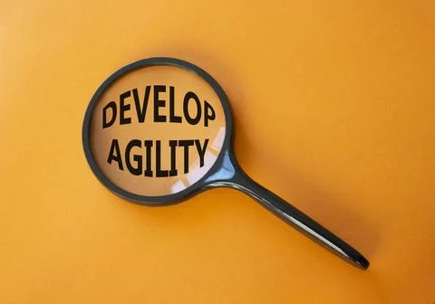 Develop agility symbol. Concept word Develop agility on magnifying glass. B.. 写真素材