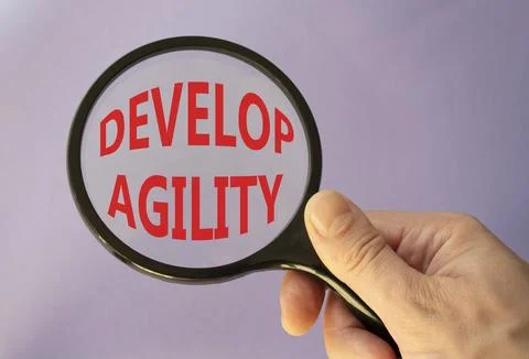 Develop agility symbol. Concept word Develop agility on magnifying glass. B.. Stockfoto's