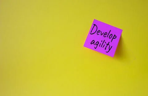 Develop agility symbol. Pink steaky note with concept words Develop Agility.. Stock Photos